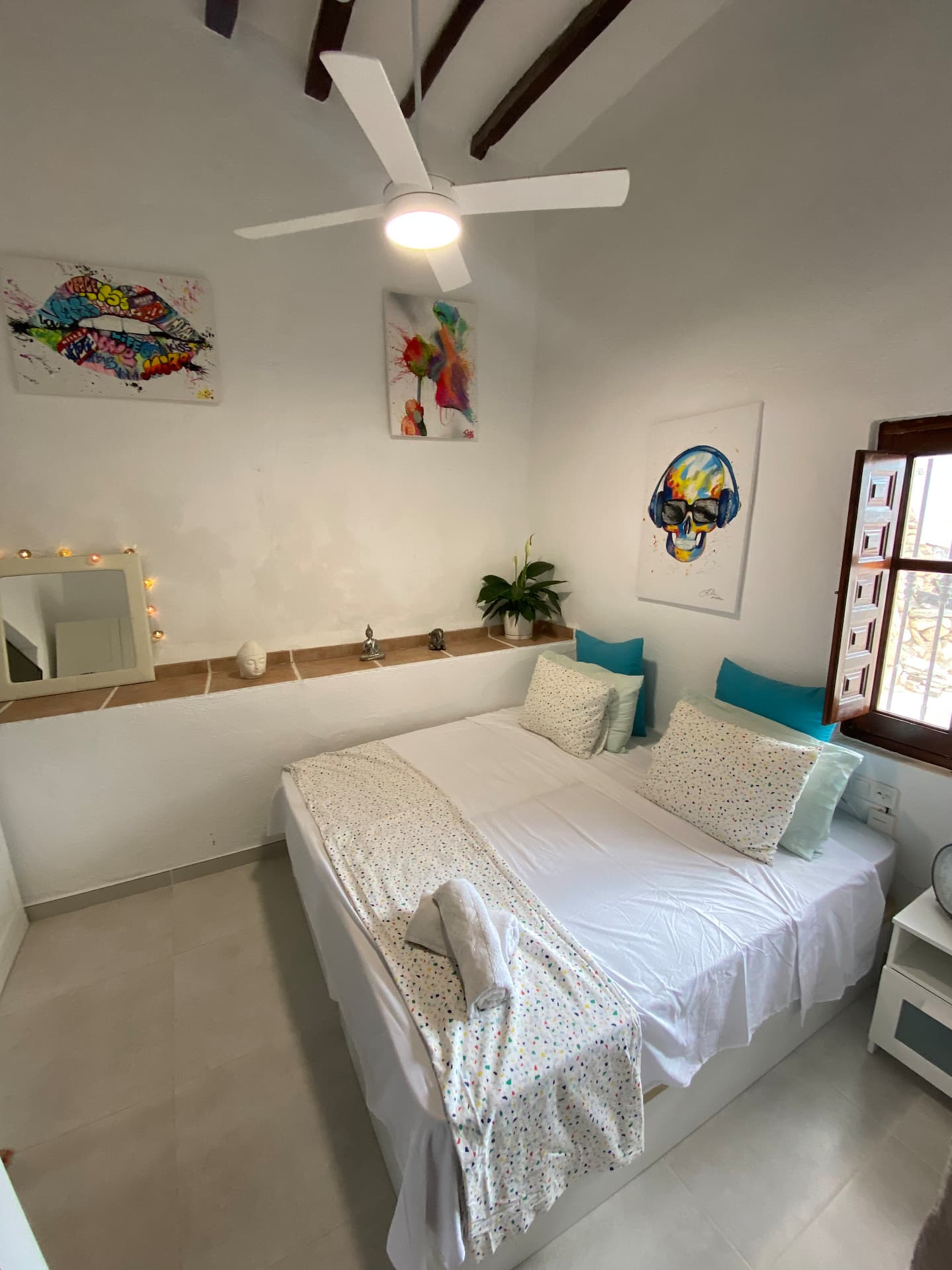 Bedroom with art and wooden beams
