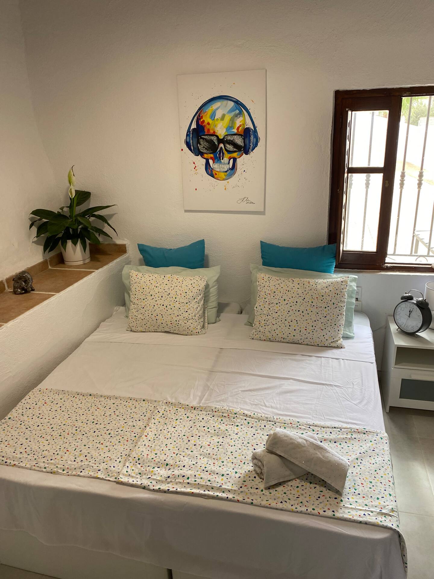 Double bedroom with turquoise cushions