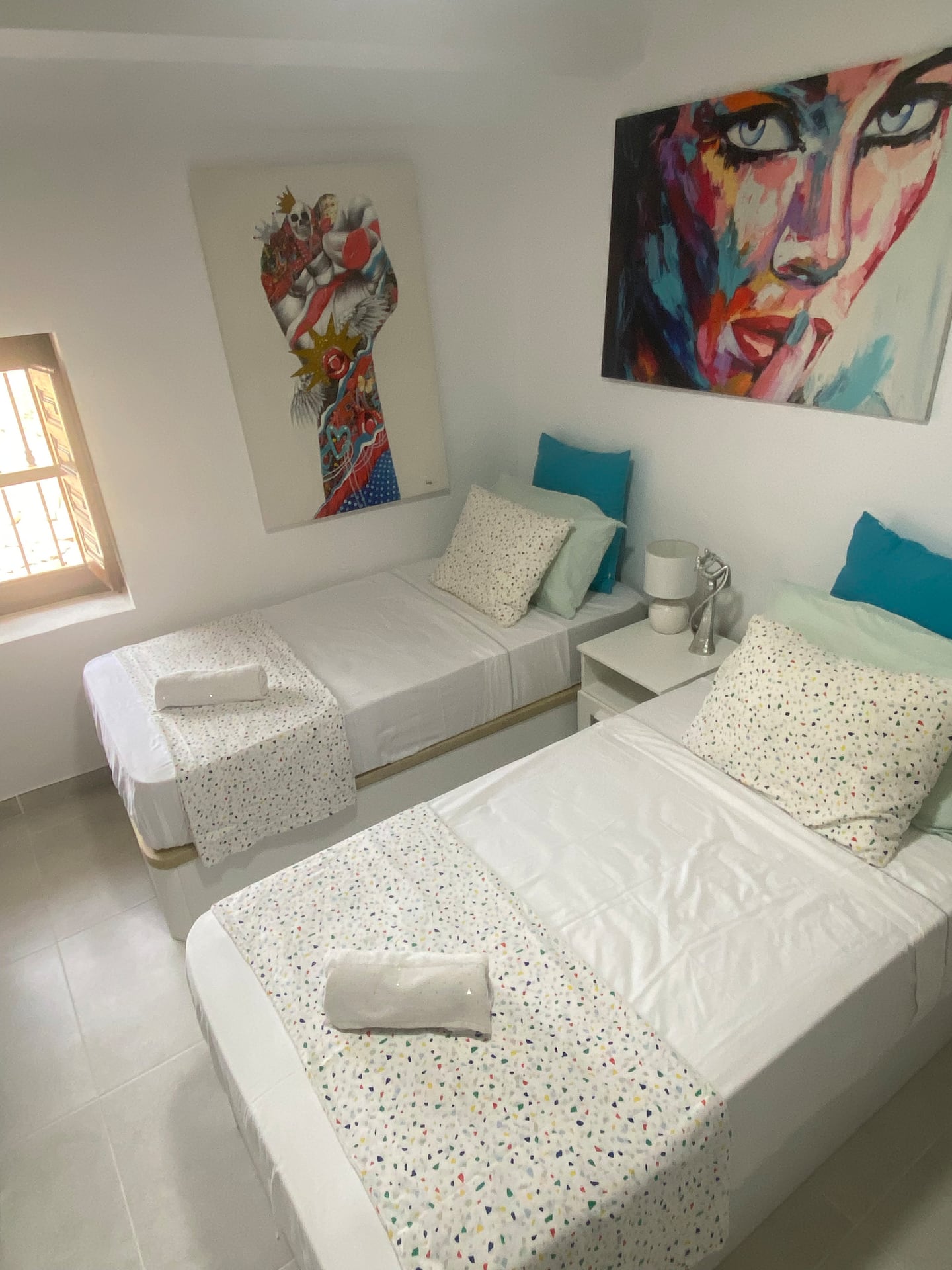 Twin bedroom with colourful art